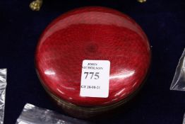 A red Guilloche enamel circular box and cover.
