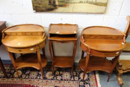 A pair of hardwood oval occasional tables and a similar table.