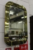 A brass framed mirror.