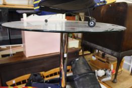 A glass and chrome circular table.