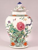 A CHINESE FAMILLE ROSE PORCELAIN JAR & COVER - decorated with scenes of native floral landscape