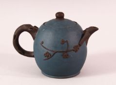 A CHINESE YIXING CLAY TEAPOT - with a blue ground and raised prunus decoration, the base with an