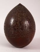 A SMALL CARVED COCONUT 'BUGBEAR', the sides carved with sailors and horsemen amongst floral