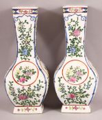 A PAIR OF CHINESE STYLE PORCELAIN VASES, painted with flowers, 31cm high.