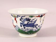 A CHINESE DOUCAI PORCELAIN HORSE CUP - depicting four horses amongst clouds, the base with a 6