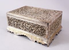 A 19TH CENTURY INDIAN OPENWORK WHITE METAL LIDDED BOX, decorated in open work depicting birds and