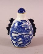 A CHINESE BLUE AND WHITE TWIN HANDLED PORCELAIN SNUFF BOTTLE, painted with dragons, 7cm.