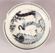 A CHINESE BLUE & WHITIE PORCELAIN PLATE, decorated with a bird and flora, the underside with a six