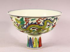 A CHINESE DOUCAI DECORATED PORCELAIN STEM BOWL - decorated with dragon interior, repeated exterior