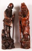 TWO CHINESE CARVED HARDWOOD FIGURES - one inlaid with silver depicting shou lao, 41cm high, together