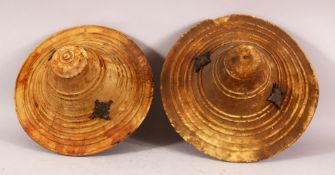 TWO 19TH CENTURY ARAB OMANI THICK LEATHER HAND SHEILDS / BUCKLERS, each with two metal star shaped