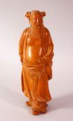 A CHINESE CARVED HARD WOOD FIGURE OF AN IMMORTAL - the figure in traditional gowns with his front