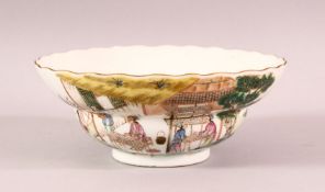 A CHINESE FAMILLE VERTE PORCELAIN BOWL, the sides painted with script and scenes of figures carrying