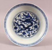A CHINESE MING STYLE BLUE & WHITE PORCELAIN DRAGON DISH, With dragons and lotus, the base with a six