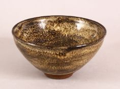 A CHINESE POTTERY TEA BOWL, with mottled glaze, 13cm diameter.
