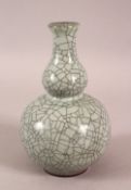 A SMALL 20TH CENTURY CHINESE CRACKLE GLAZED PORCELAIN DOUBLE GOURD VASE - 15cm.
