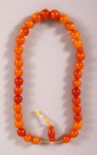 A GOOD SET OF CHINESE OR ISLAMIC AMBER PRAYER BEADS, the string comprising of 36 beads and toggle