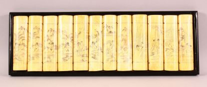 A CHINESE CARVED & STAINED BONE EROTIC PANEL - the panel simulating 12 book ends , each section