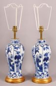 A PAIR OF CHINESE KANGXI STYLE BLUE & WHITE PORCELAIN VASE LAMPS - with panel decoration of