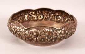 AN INDIAN SILVER BOWL, with embossed and chased floral decoration, 18cm diameter.