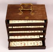 A CHINESE 20TH CENTURY MAH JONG SET IN WOODEN BOX - comprising 144 pieces of bamboo & bone tiles,
