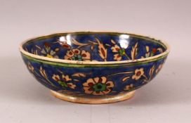 A DECORATIVE IZNIK STYLE POTTERY BOWL, painted with flowers and foliate decoration, 18.5cm