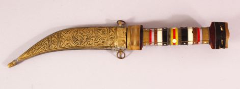 AN EASTERN HARDSTONE HANDLED BRASS SHEATH DAGGER - the hilt formed from stacked variations of hard