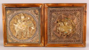A PAIR OF FRAMED INDIAN EMBROIDERED PANELS, each centre with roundel depicting a figure on a horse