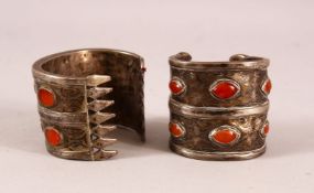 TWO ISLAMIC SILVER BANGLES, inset with stones - possibly amber.