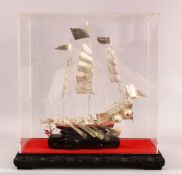 A 20TH CENTURY CHINESE SILVER MODEL OF A JUNK / SHIP - the ship mounted to a hardwood base, hosed in