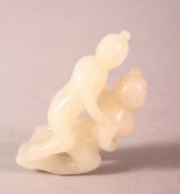 A EASTERN CARVED JADE PENDANT - EROTIC THEME - two figures during intercourse, 5.5cm