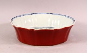 A CHINESE MING STYLE FLAMBE GLAZED BLUE & WHITE PORCELAIN MOULDED DISH - the exterior with a