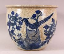 A CHINESE CRACKLE GLAZED PORCELAIN PLANT POT - decorated in underglaze blue of a bird amongst flora,