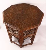 A FINE 19TH CENTURY INDIAN CARVED WOOD TRAVELLING FOLDING TABLE - the folding legs with finely