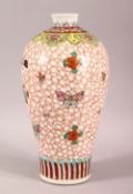 A CHINESE FAMILLE ROSE PORCELAIN VASE, painted with butterflies and flowers, six character mark to