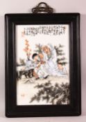 A CHINESE FAMILLE ROSE PORCELAIN TILE PANEL - the panel decorated depicting an immortal and boy