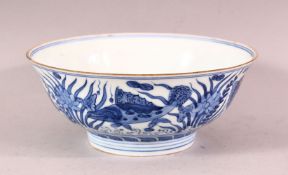 A CHINESE MING STYLE BLUE & WHITE PORCELAIN BOWL - decorated with scenes of fish and reeds, the base