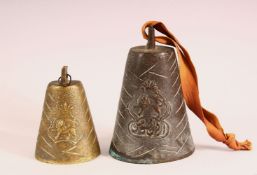 TWO BRONZE QAJAR CATTLE BELLS - each with raised lion decoration one with calligraphy, 11cm &