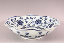 A CHINESE MING STYLE BLUE & WHITE PORCELAIN MOULDED BOWL, decorated with formal lotus rosette, the
