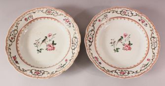 A PAIR OF 18TH CENTURY CHINESE FAMILLE ROSE PORCELAIN PLATES - each decorated with scenes or