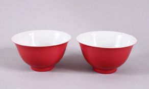 A PAIR OF 19TH / 20TH CENTURY CHINESE RUBY RED GLAZED PORCELAIN TEA BOWLS, with a ruby red / pink