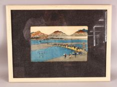 A JAPANESE FRAMED WOOD BLOCK PRINT - depicting figures in village life, 58cm x 48cm