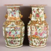TWO 19TH CENTURY CHINESE CANTON FAMILLE ROSE PORCELAIN VASES, with panel decoration of figures,