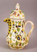 AN 18TH CENTURY TURKISH KUTAHYA POTTERY COFFEE POT - decorated with native floral decoration, 20cm