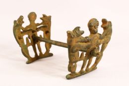AN UNUSUAL IRON HORSE GRIP/BITE, the pierced ends with a figure and two animals, 25cm long.