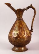 A SELJUK STYLE BRASS EWER, with engraved bands of calligraphy, 34.5cm high.