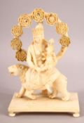 A FINE 19TH CENTURY CARVED IVORY FIGURE OF GODDESS PARVATI HOLDING GANESH, sat upon a lion on a