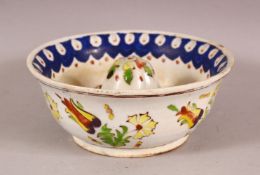 AN 18TH CENTURY TURKISH KUTAHYA POTTERY LEMON SQUEEZE, with floral decorations, 14cm diameter,