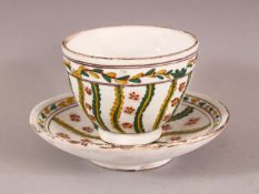 AN 18TH CENTURY TURKISH KUTAHYA POTTERY CUP & SAUCER - decorated with yellow and green floral