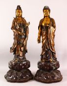 A LARGE PAIR OF CHINESE GILT BRONZE FIGURES OF DEITYS - one of guanyin, the other of buddha, both in